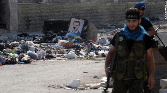 A damaged portrait of President Bashar al-Assad sits among piles of debris at a checkpoint manned by Syrian rebels in Aleppo on Wednesday.