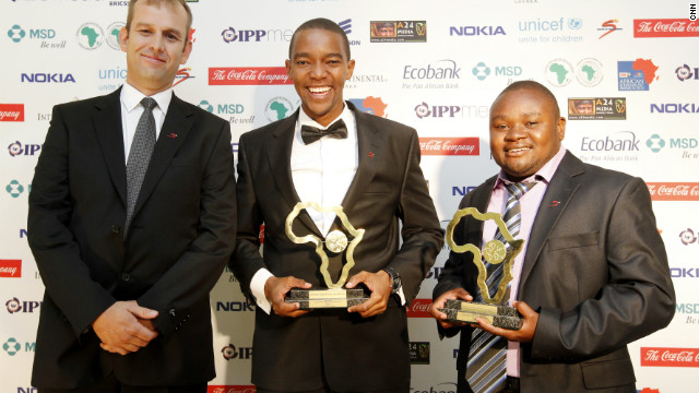 Certainly happy about the win, joint winners Waihiga Mwaura (center) and Jephitha Mwai Mwangi (right) smile after they are awarded the Sport Award for their work on Maasai cricket warriors on Citizen TV in Kenya.