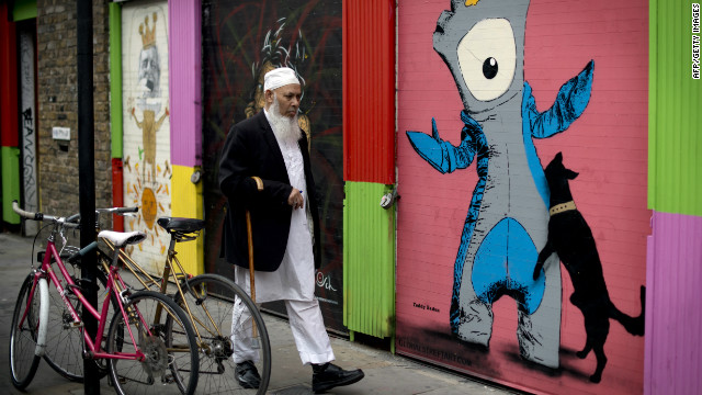 A man walks past graffiti depicting 'Wenlock' (R), one of the official Olympic mascots, in east London two days before the start of the Games.