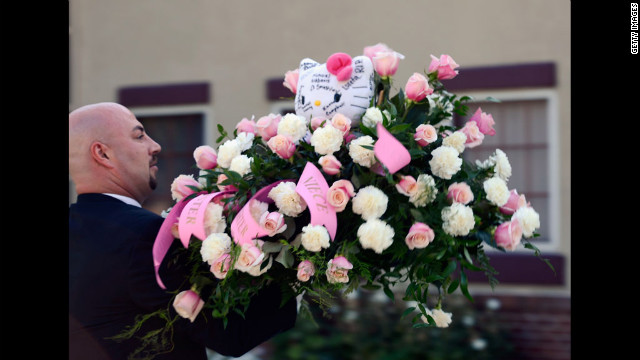 Hello Kitty-themed flowers are sent to shooting victim Micayla Medek's funeral Thursday in Denver.