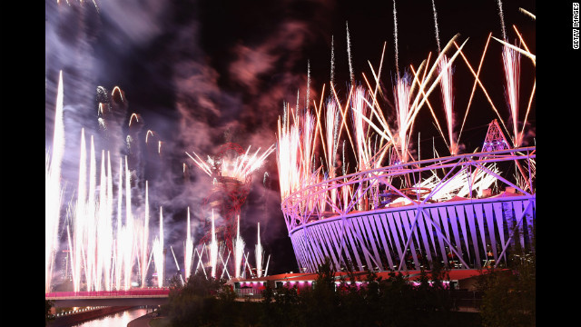 Fireworks cast a purple glow over the Olympic Stadium.
