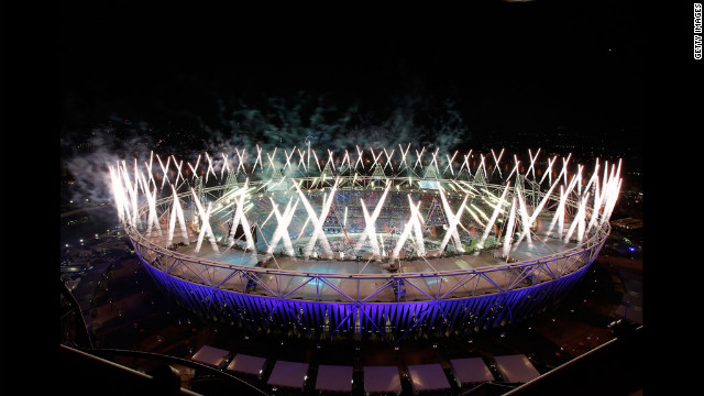 Fireworks ignite over the Olympic Stadium.