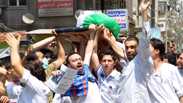 Syrians carry the body of a man allegedly killed in the bombardment of Sukari, southwest of Aleppo, by Syrian regime forces on July 27.