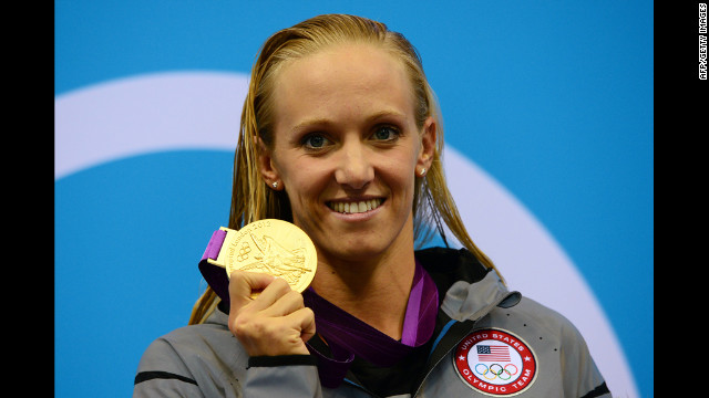 U.S. swimmer Dana Vollmer poses on the podium after winning a gold medal in the women's 100-meter butterfly final at the London Olympics on Sunday, July 29.
