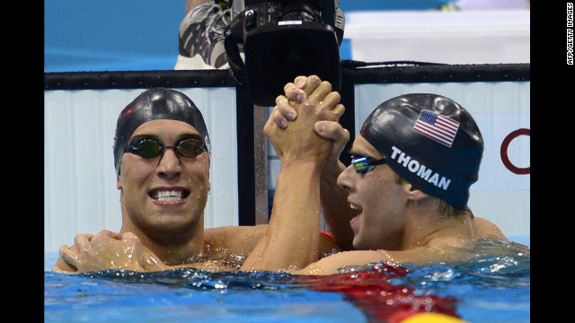 American Matthew Grevers (left) celebrates winning gold with silver medalist and fellow American Nick Thoman at the finish of the men's 100-meter backstroke final swimming on Monday.