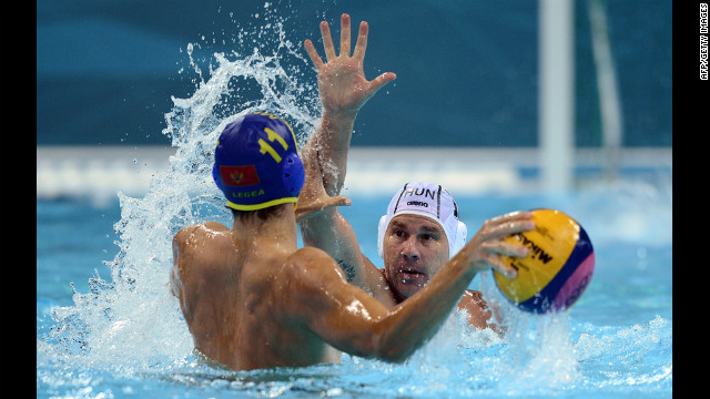 Hungary's Peter Biros, right, challenges Montenegro's Vladimir Gojkovic during the men's water polo preliminary match Tuesday.
