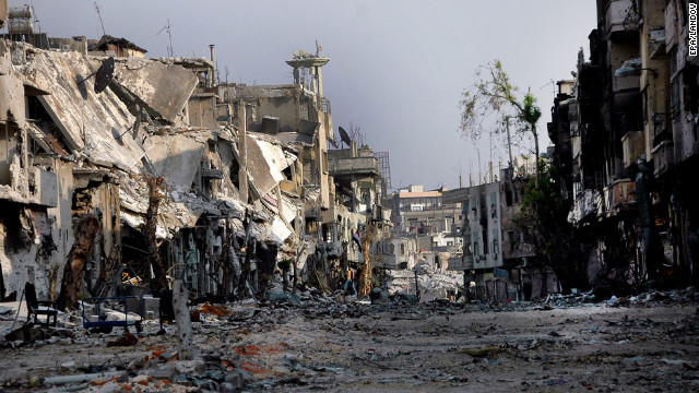 A photo released by Syrian Arab News Agency depicts damaged buildings in Homs on Monday, July 30.