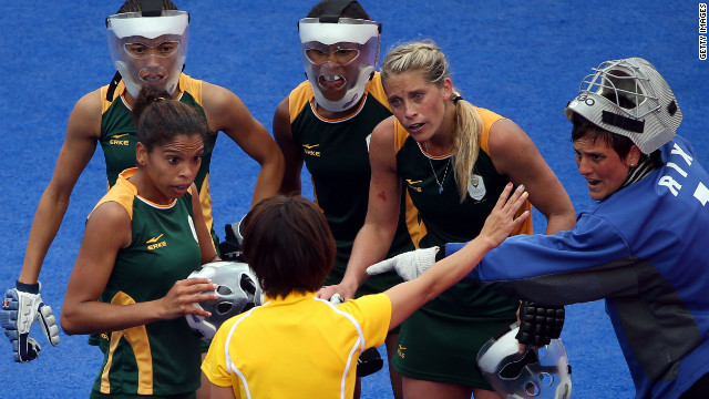 Members of the South African women's field hockey team protest to the referee during a match against New Zealand on Tuesday.
