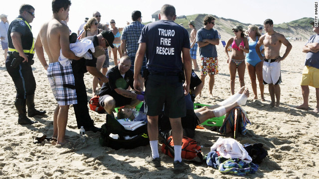 A man is treated for apparent shark bites on his legs Monday at Cape Cod's Ballston Beach.