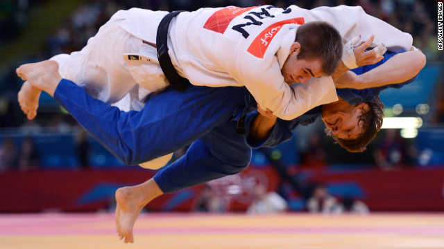 Canada's Antoine Valois-Fortier, in white, gets taken down by Russia's Ivan Nifontov during the men's under 81-kilogram quarterfinal judo match on Tuesday.