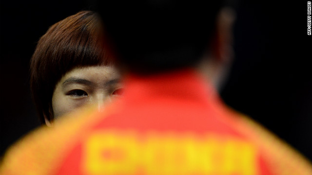 Li Xiaoxia of China talks with her coach during a table tennis women's quarterfinals match Tuesday.