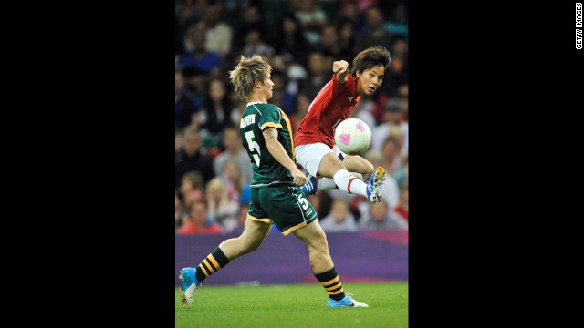 South Africa's Janine Van Wyk, left, and Mana Iwabuchi of Japan go after the ball during the women's football first round match Tuesday at Millennium Stadium in Cardiff, Wales.
