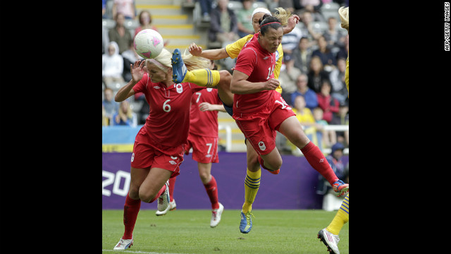 Canada's Melissa Tancredi, right, heads the ball to score her team's second goal against Sweden in Newcastle-upon-Tyne.