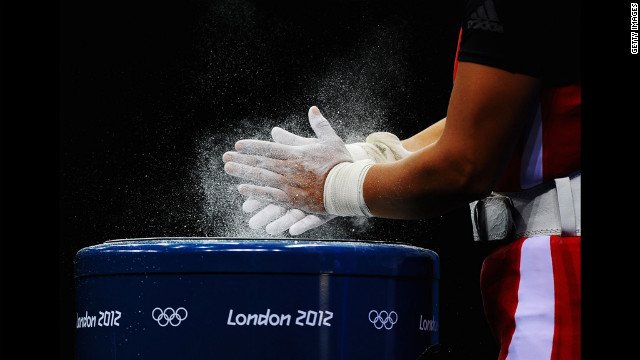 Silvana Saldarriaga of Peru chalks her hands before the women's 63-kilogram weightlifting final.