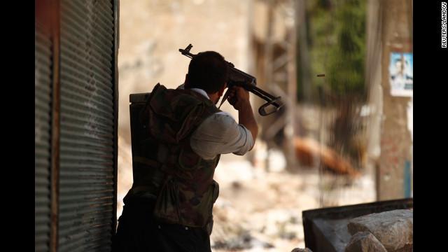 A member of the Free Syrian Army fires at forces loyal to President Bashar Al-Assad in a district of Aleppo called Salah Edinne on Tuesday.
