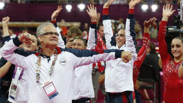 U.S. women's gymnastics coach John Geddert celebrates with his team after they won the gold in the team competition Tuesday.