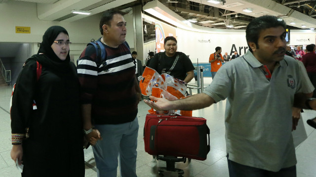 Saudi athlete Wojdan Shaherkani, left, arrives in London with her father for the Olympics on July 25.