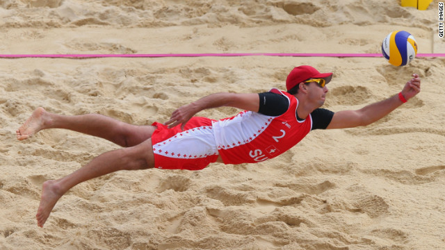Jefferson Bellaguarda of Switzerland dives for a shot during the men's beach volleyball preliminary match between Brazil and Switzerland on Tuesday.