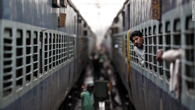 A passenger peers out the window of a train as he waits for electricity to be restored at a railway station in New Delhi on Tuesday. India suffered its second huge power failure in two days on Tuesday, depriving as much as half of the vast and populous country of electricity and disrupting transport networks.