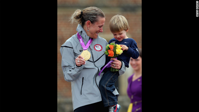 Armstrong celebrates the gold with her son, Lucas, during the medal ceremony. 