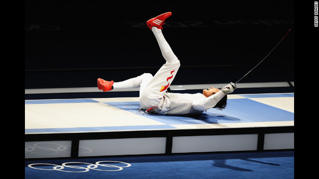 Sheng Lei of China celebrates winning the men's foil individual gold medal bout against Alaaeldin Abouelkassem of Egypt.