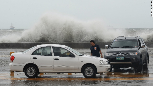 High waves splash up Wednesday along Toxas Boulevard, the famous roadway that runs along Manila Bay.