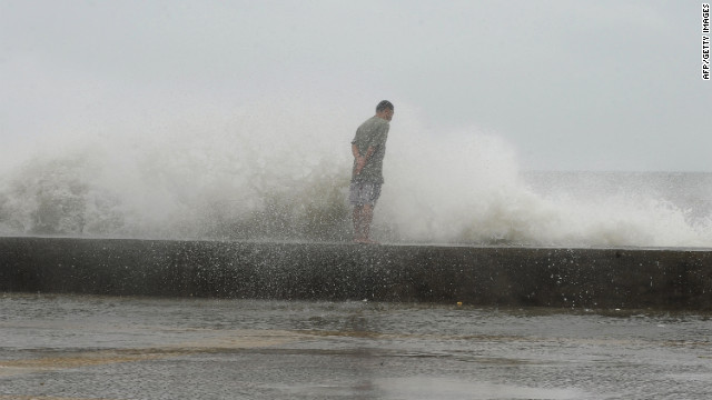 A man braves high waves along Manila's Roxas Boulevard on Wednesday.