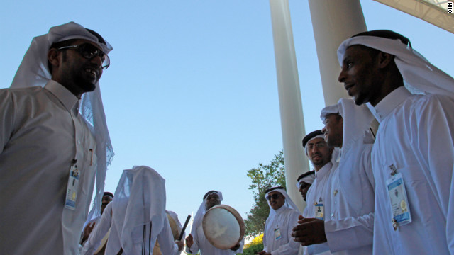 Qatari musicians drum up visitors to the country's pavilion. "It's about people, not business," says its manager Mona Sulaiti. 