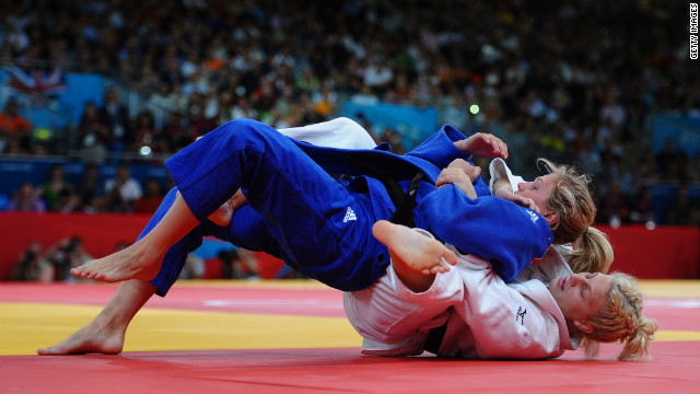Kayla Harrison, in white, and Britain's Gemma Gibbons fight for first place.