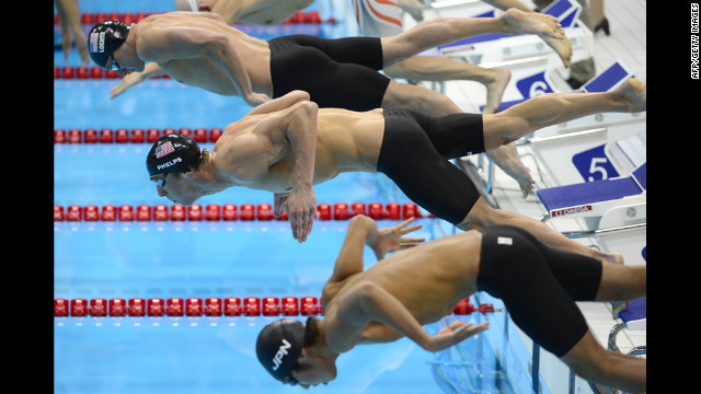 Phelps, center, dives next to U.S. swimmer Ryan Lochte, top, and Japan's Kosuke Hagino at the start of the 200-meter individual medley.