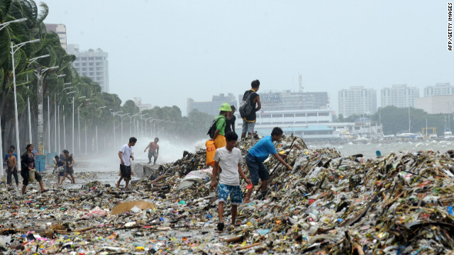 People pick up recyclable materials among the trash washed ashore along's Manila's Roxas Boulevard. 
