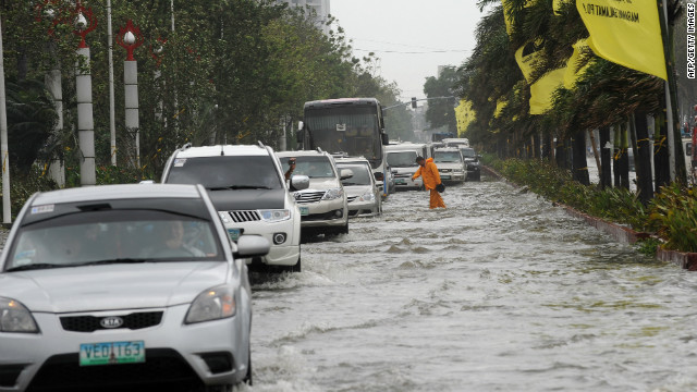 Motorists drive through floodwaters along Manila's Roxas Boulevard in Manila on Wednesday. 
