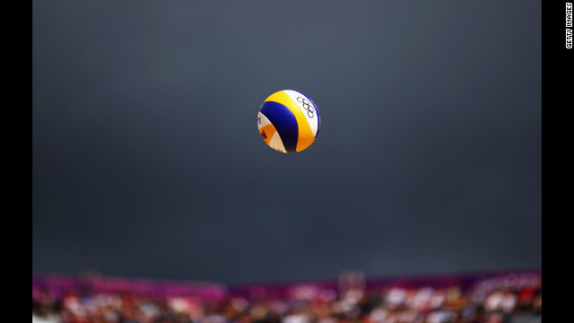 The ball gets served during a men's beach volleyball match between Switzerland and Poland.