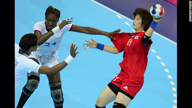 France's Mariama Signate, left, vies with South Korea's Ryu Eun Hee during a women's preliminary handball match.