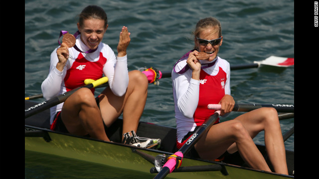 Bronze medalists Magdalena Fularczyk, left, and Julia Michalska of Poland celebrate their medals during the ceremony for the women's double sculls final.