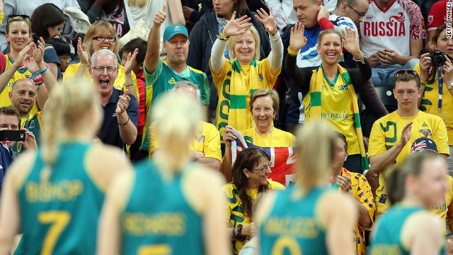 Fans cheers Australia's players as they leave the court after defeating Russia in a women's basketball preliminary round.