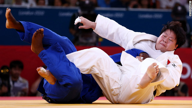 China's Wen Tong, in white, and Idalys Ortiz of Cuba compete in the women's over 78-kilogram judo event.