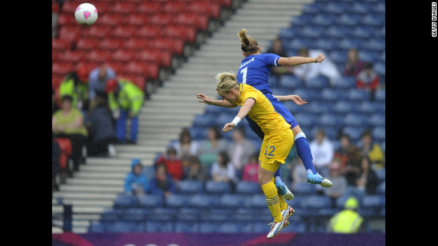 Corine Franco of France and Marie Hammarstrom of Sweden battle for the ball during a women's football quarterfinal match.