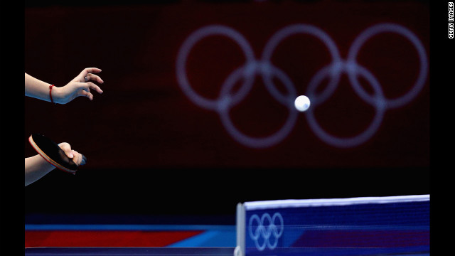Tianwei Feng of Singapore competes during the women's team table-tennis match against Poland.