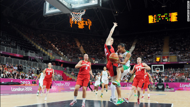 Brazilian guard Joice Rodrigues, second from right, vies with Canadian forward Lizanne Murphy during a women's preliminary round basketball match.
