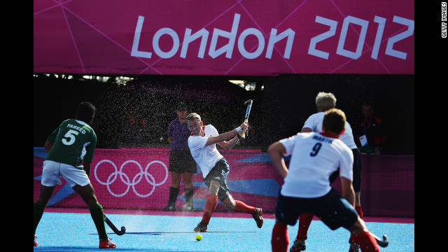 Britain's James Tindall, center, makes a move during the men's field hockey match between Britain and Pakistan.