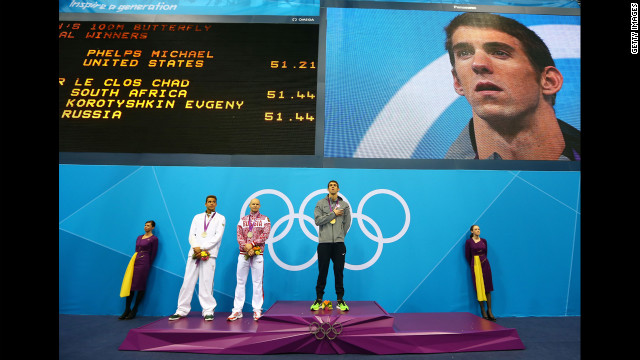 Left to right: Silver medallists Chad le Clos of South Africa and Evgeny Korotyshkin of Russia and gold medallist Michael Phelps listen to the United States national anthem during the medal ceremony for the men's 100-meter butterfly final on Friday, August 3.