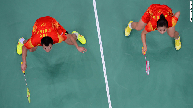 China's Xu Chen, left, and Ma Jin, right, play against China's Zhang Nan and Zhao Yunlei (not pictured) during the mixed doubles gold medal match.