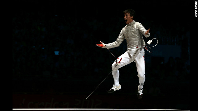 Woo Young Won of South Korea celebrates after defeating Romania to win the gold medal in the men's sabre team fencing.