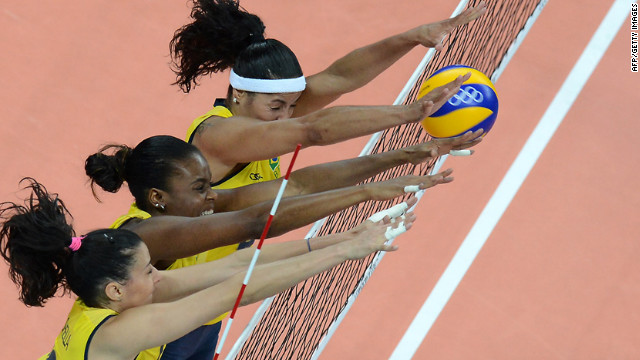 From left, Brazil's Sheilla Castro, Fabiana Claudino and Paula Pequeno attempt to block during a women's preliminary pool volleyball match between Brazil and China.