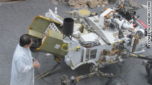 James Wang, test conductor for Curiosity, with the test model of the rover used for experiments on Earth.