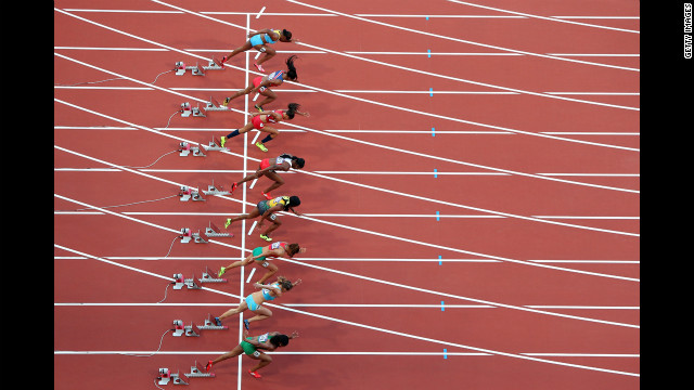 Athletes start in the women's 100-meter semifinal at Olympic Stadium.