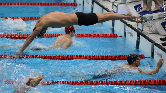 Michael Phelps, center, competes in the men's 4x100-meter medley relay final.