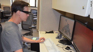 Scott Maxwell wears 3-D glasses to simulate driving a Mars rover at JPL\'s Mission Operations area.