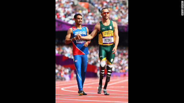 Luguelin Santos, left, of the Dominican Republic shakes hands with Oscar Pistorius of South Africa after competing in the preliminary heat of the men's 400-meter on Saturday.